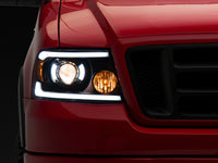 Raxiom 04-08 Ford F-150 Axial Series Projector Headlights with LED Bar- Black Housing- Clear Lens