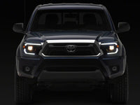Raxiom 12-15 Toyota Tacoma Axial Series Switchback Projector Headlights- Black Housing- Clear Lens