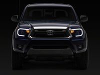 Raxiom 12-15 Toyota Tacoma Axial Series Headlights/Seq LED Bar- Black- Clear Lens