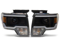 Raxiom 09-14 Ford F-150 Axial Series Projector Headlights w/ LED Light Bar- Blk Housing (Clear Lens)